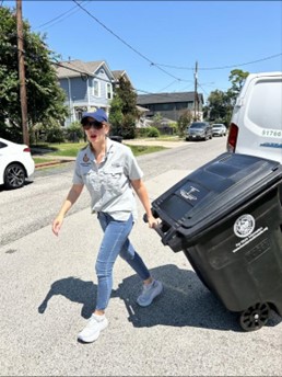 Council Member Kamin Pulling a Garbage Bin
